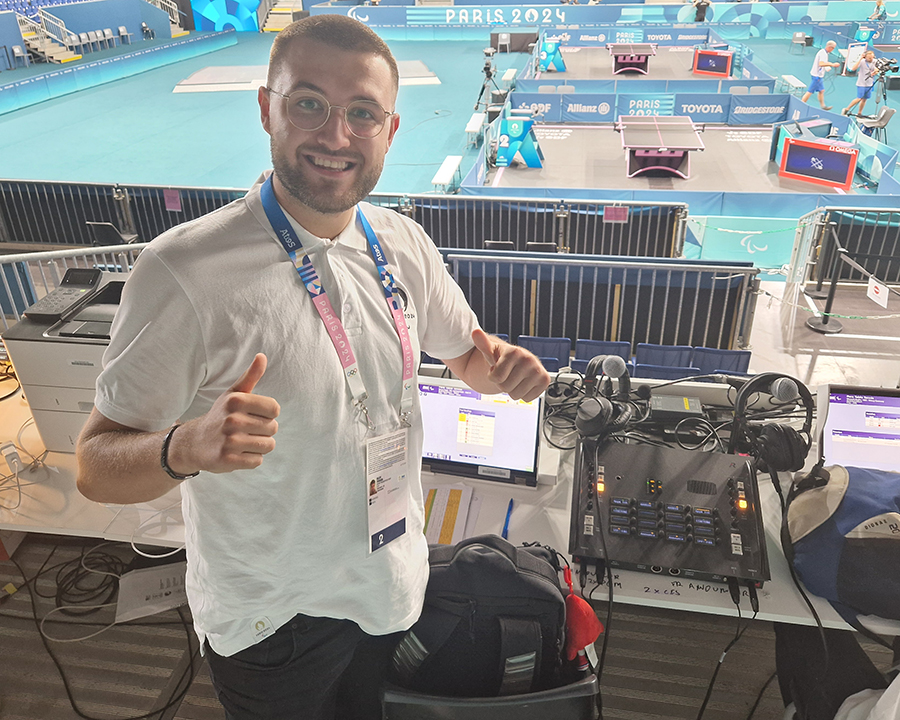Fraser Riley beside the broadcasting equipment overlooking the table tennis courts at Paris 2024